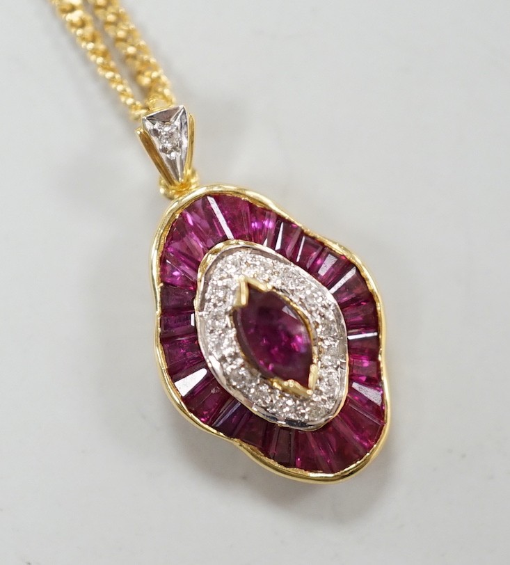 A modern 18k yellow metal, ruby and diamond cluster set quatrefoil shaped pendant, overall 25mm, on an 18ct gold fine link chain, 44cm, gross weight 8.1 grams.